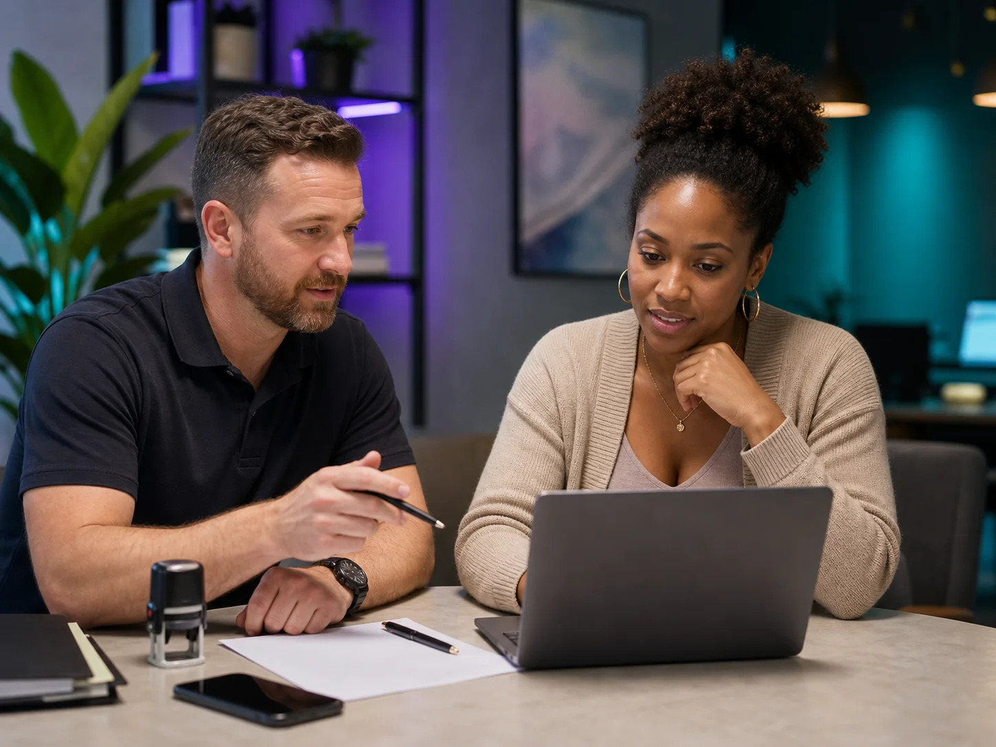 Family member searching on a laptop while speaking with a mobile notary
